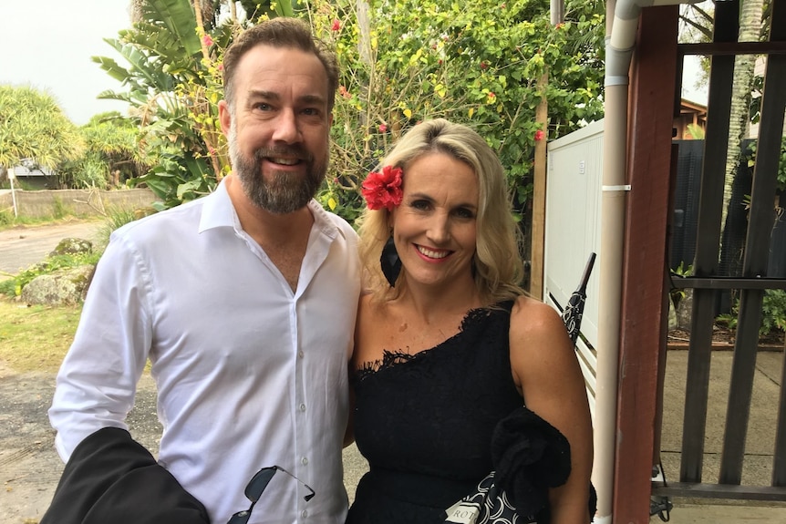 Tara Castle smiles as she stands next to her late husband.